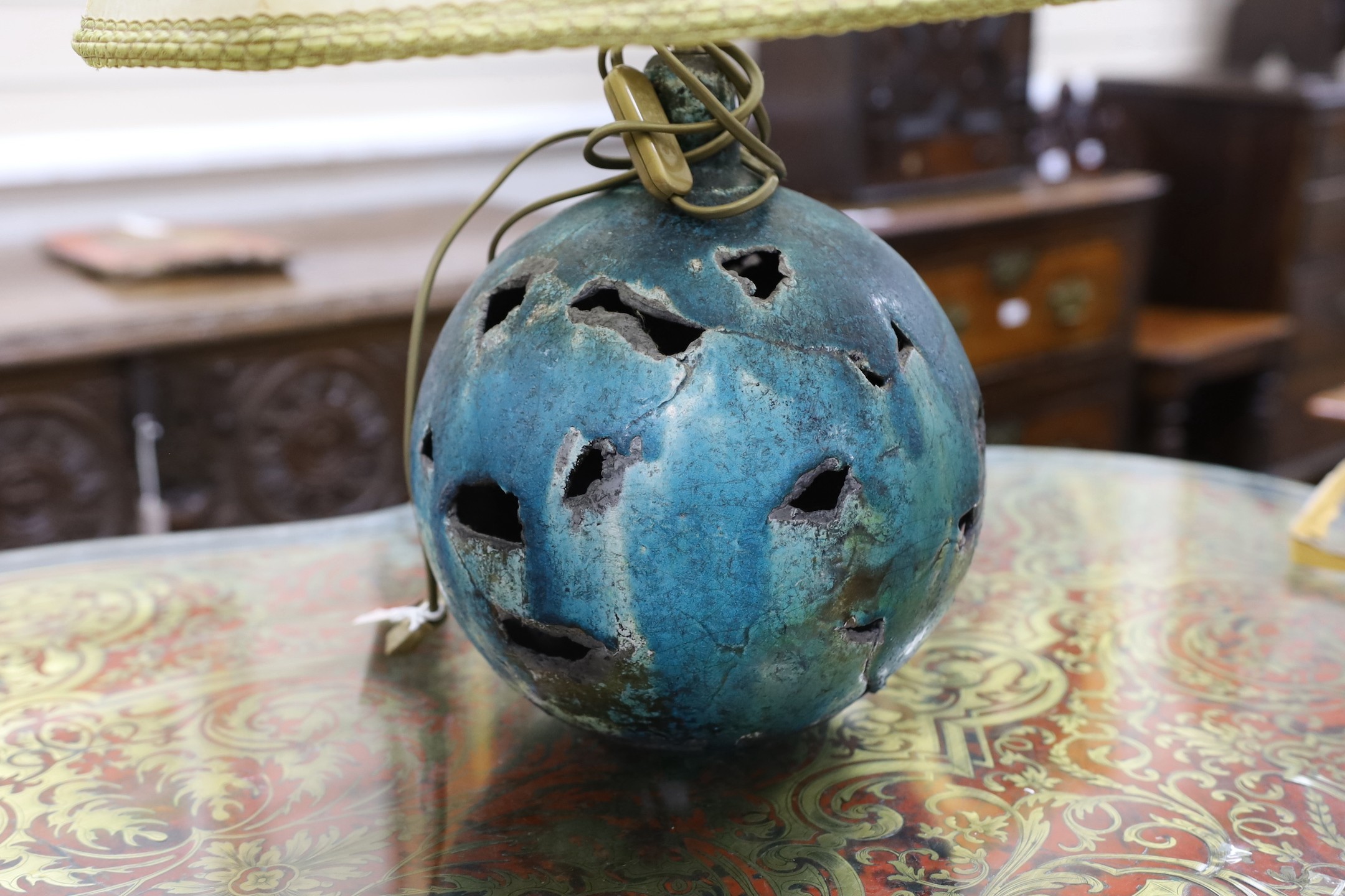 A pair of pierced pottery table lamps with vellum shades, 28cm